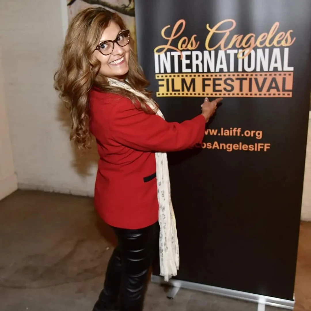 Festival guest beside the Los Angeles International Film Festival banner