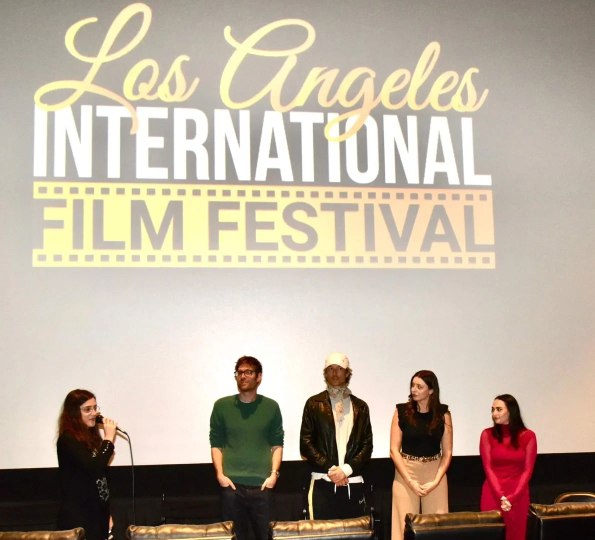Five filmmakers seated beneath the LAIFF screening logo
